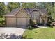 Charming home featuring a lush landscaped yard and a two-car garage with a traditional-style exterior at 591 Briarmeade Sw Dr, Marietta, GA 30064
