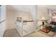 Bright hallway with white railing, carpet, and decorative lighting at 591 Briarmeade Sw Dr, Marietta, GA 30064