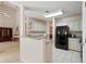 Kitchen featuring white cabinets and granite countertops, with a view into the living room at 591 Briarmeade Sw Dr, Marietta, GA 30064
