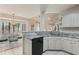 White kitchen featuring granite countertops, stainless steel appliances, and an adjacent breakfast nook with bay windows at 591 Briarmeade Sw Dr, Marietta, GA 30064