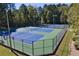 Outdoor community tennis courts with new fencing and well-maintained blue and green playing surfaces at 591 Briarmeade Sw Dr, Marietta, GA 30064