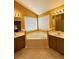 Bright bathroom featuring double sinks and a corner soaking tub with tile flooring at 1112 Gather Dr, Lawrenceville, GA 30043