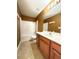 Cozy bathroom featuring tub shower combo, single sink vanity, toilet, and tile flooring at 1112 Gather Dr, Lawrenceville, GA 30043