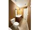 Narrow bathroom featuring single sink vanity, toilet, tile flooring, and a door to a closet at 1112 Gather Dr, Lawrenceville, GA 30043