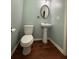 Elegant half bath featuring a pedestal sink and oval mirror at 1112 Gather Dr, Lawrenceville, GA 30043