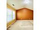 Bedroom with a pitched roof, large window, and tan accent wall at 1112 Gather Dr, Lawrenceville, GA 30043