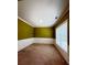 Living room with olive green walls, white trim and carpeted floor at 1112 Gather Dr, Lawrenceville, GA 30043