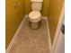 Powder room featuring toilet and tile flooring at 1112 Gather Dr, Lawrenceville, GA 30043