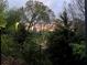View of the tree-lined backyard area with glimpses of the nearby Beltline trail at sunset at 400 Village Ne Pkwy # 203, Atlanta, GA 30306