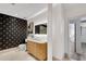 Stylish bathroom boasts patterned accent wall, marble counter, and modern fixtures at 400 Village Ne Pkwy # 203, Atlanta, GA 30306