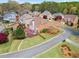 Aerial view of backyard with lush lawn, mature trees, flowering shrubs, and deck for outdoor enjoyment at 4093 Tritt Homestead Dr, Marietta, GA 30062