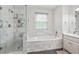 Bright bathroom with tiled shower, soaking tub, and white vanity with countertop space at 4093 Tritt Homestead Dr, Marietta, GA 30062