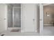Modern bathroom featuring a glass-enclosed shower, tiled floor and white doors at 4093 Tritt Homestead Dr, Marietta, GA 30062