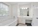 Bright bathroom features a soaking tub, walk-in shower, white vanity and a large mirror at 4093 Tritt Homestead Dr, Marietta, GA 30062