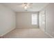 Neutral carpeted bedroom with natural light and a ceiling fan at 4093 Tritt Homestead Dr, Marietta, GA 30062