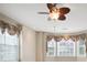 Sunlit bedroom featuring windows with decorative cornices and a ceiling fan at 4093 Tritt Homestead Dr, Marietta, GA 30062