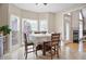 Bright breakfast area with large windows and table, adjacent to a modern kitchen at 4093 Tritt Homestead Dr, Marietta, GA 30062