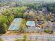 Aerial view showcases community with pool, tennis courts, clubhouse and mature trees at 4093 Tritt Homestead Dr, Marietta, GA 30062
