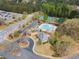 Aerial view of community pool, tennis courts, clubhouse, parking and surrounding green spaces at 4093 Tritt Homestead Dr, Marietta, GA 30062