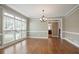 Traditional dining room featuring hardwood floors, large windows, and elegant chandelier at 4093 Tritt Homestead Dr, Marietta, GA 30062
