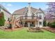 Beautiful back exterior view of home with a large deck, nice yard, and lush landscaping at 4093 Tritt Homestead Dr, Marietta, GA 30062