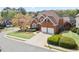 Aerial view of a beautiful brick home with a well-manicured lawn and a two-car garage at 4093 Tritt Homestead Dr, Marietta, GA 30062