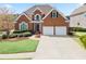 Charming brick home with a well-manicured lawn and a two-car garage at 4093 Tritt Homestead Dr, Marietta, GA 30062