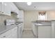Well-lit kitchen featuring stainless steel appliances, white cabinetry, and tiled floors at 4093 Tritt Homestead Dr, Marietta, GA 30062