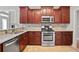 Modern kitchen with stainless steel appliances, granite countertops, and dark wood cabinets at 4093 Tritt Homestead Dr, Marietta, GA 30062