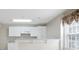 Kitchen with white cabinets, a window and a breakfast bar with an open layout at 4093 Tritt Homestead Dr, Marietta, GA 30062