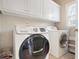 Laundry room with front loading Samsung washer and dryer and storage at 4093 Tritt Homestead Dr, Marietta, GA 30062
