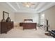 Spacious main bedroom featuring tray ceilings, neutral carpeting, and a large window at 4093 Tritt Homestead Dr, Marietta, GA 30062