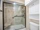 Accessible shower with a glass door and a built-in seat for convenience at 4093 Tritt Homestead Dr, Marietta, GA 30062