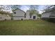 A grassy backyard with a patio and sliding glass doors, perfect for outdoor activities at 890 Shiloh Ridge Nw Run, Kennesaw, GA 30144