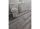 Small bathroom with new light gray wood-look laminate flooring and white vanity at 890 Shiloh Ridge Nw Run, Kennesaw, GA 30144