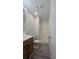 Bathroom featuring a shower, wood vanity, and tiled floors, offering a functional space at 890 Shiloh Ridge Nw Run, Kennesaw, GA 30144