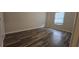 A bedroom with sleek wood-look floors and a window, offering a modern and clean aesthetic at 890 Shiloh Ridge Nw Run, Kennesaw, GA 30144