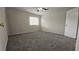 Light-filled bedroom featuring a ceiling fan, large window, and carpet flooring at 890 Shiloh Ridge Nw Run, Kennesaw, GA 30144