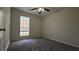 Carpeted bedroom featuring a ceiling fan and a window providing ample natural light at 890 Shiloh Ridge Nw Run, Kennesaw, GA 30144