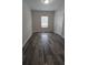 A well-lit bedroom showcases stylish wood-look floors and a bright window at 890 Shiloh Ridge Nw Run, Kennesaw, GA 30144