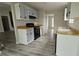 Galley kitchen featuring gray cabinets, black appliances, and laminate flooring at 890 Shiloh Ridge Nw Run, Kennesaw, GA 30144