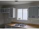 Bright kitchen with gray cabinets, laminate countertops, and stainless steel sink at 890 Shiloh Ridge Nw Run, Kennesaw, GA 30144