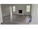 Spacious living room featuring a fireplace, large windows, and modern gray laminate flooring at 890 Shiloh Ridge Nw Run, Kennesaw, GA 30144