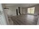 Bright living room with gray laminate floors, fireplace, and large windows at 890 Shiloh Ridge Nw Run, Kennesaw, GA 30144