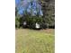 Overgrown backyard features a shed surrounded by trees, creating a private and serene outdoor space at 1511 Stonewood Dr, Norcross, GA 30093