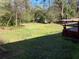 View of the deck and expansive backyard featuring a large lawn at 1511 Stonewood Dr, Norcross, GA 30093