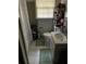 Bathroom featuring a white sink, toilet, shelving, and shower with a white curtain at 1511 Stonewood Dr, Norcross, GA 30093