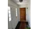 Inviting entryway with a wooden door, tiled floor, and a closet, creating a warm welcome into the home at 1511 Stonewood Dr, Norcross, GA 30093