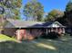 Charming brick home featuring red shutters and a covered front porch at 1511 Stonewood Dr, Norcross, GA 30093