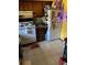 View of the kitchen featuring a white fridge, stove, and wooden cabinets at 1511 Stonewood Dr, Norcross, GA 30093